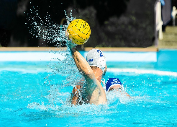 Boys palying volley ball in water